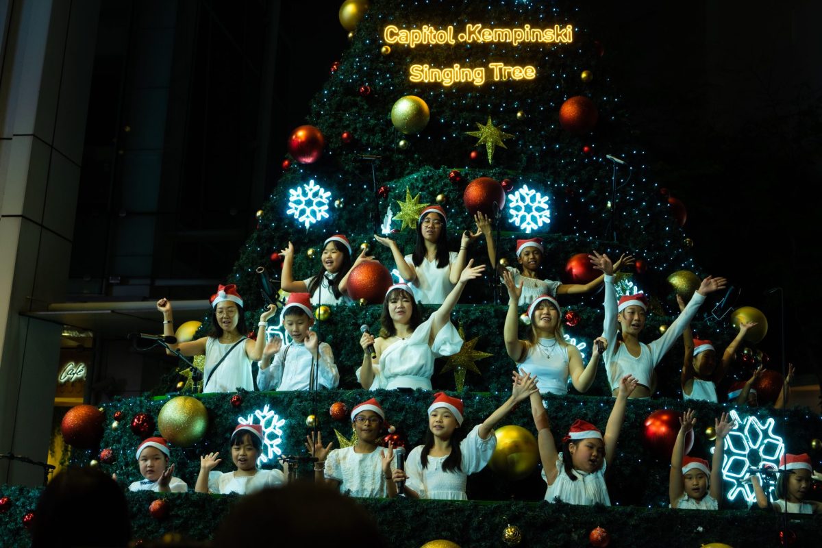 Women carol singing during a Christmas event