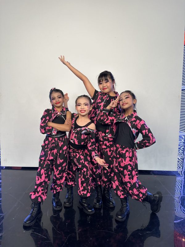ur young girls wearing matching pink-and-black camo street style outfits pose confidently